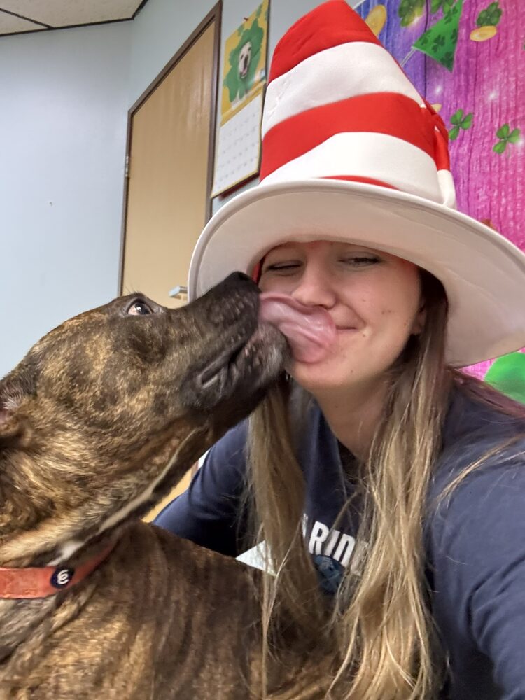 A dog giving Haley a kiss on the cheek